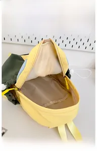 Internal display of spacious backpack with yellow zippers and colorful fabric compartments