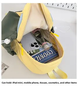 Detail view of the contrast color backpack interior showing capacity for iPad mini and phone
