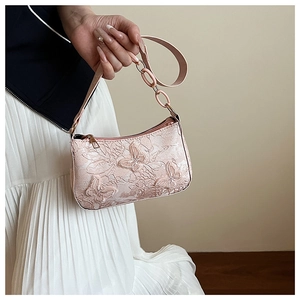 Detail of pink 3D butterfly embroidery and floral texture on women's shoulder bag