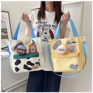 Detail of canvas tote bags with cow print and 3D patches for school and daily use