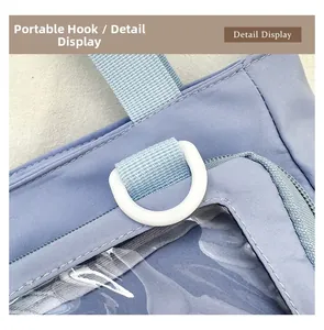 Detail view of the durable white D-ring hook and clear PVC window on purple canvas bag