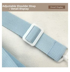 Detail of adjustable light blue shoulder strap with durable white plastic buckle