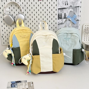 Three stylish color-block mini backpacks with embroidery and cute plush charms