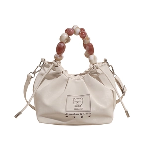 Chic pleated cream leather handbag with marble-effect beaded handle and crossbody strap