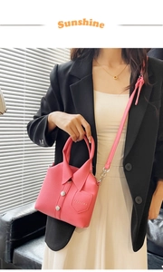 Detail of pink shirt-style handbag with lapel collar, white buttons and lychee leather texture