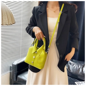 Detailed macro view of lime green leather handbag featuring a unique shirt-inspired design