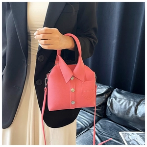 Close-up of pink shirt-style handbag with lapel details and litchi texture finish