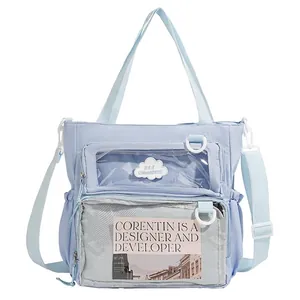 Light blue canvas tote bag with transparent windows and adjustable shoulder strap