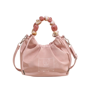 Light pink crossbody bag with beaded handle and cute bear logo for summer fashion