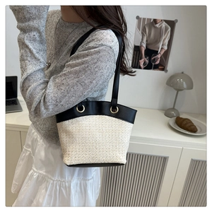 Close-up of French vintage shoulder bag with contrast stitching and gold ring hardware