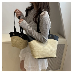 Detailed comparison of large and small woven straw tote bags with black leather trim