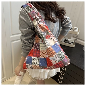 Detail of bohemian patchwork shoulder bag with floral patterns on a crossbody model