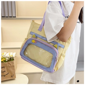 Detail of canvas ita bag featuring a transparent PVC window and cute cat ear decoration