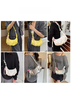 Detailed views of crescent shoulder bags in yellow, white, and silver with heart charms