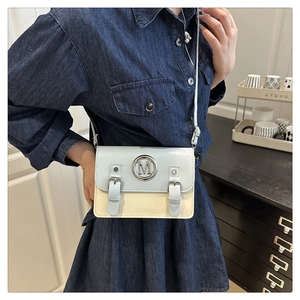 Detail of light blue and beige contrast leather bag with circular metal M buckle