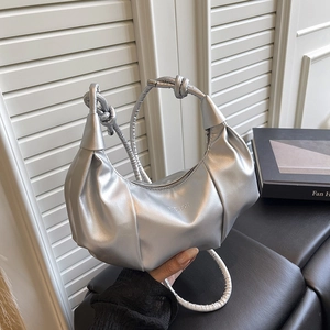 Chic silver crescent shoulder bag with metallic ruched finish and knotted handle detail