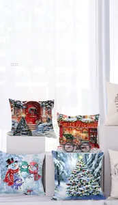 Detail view of four Christmas pillow covers with festive scenes on soft peach skin fabric