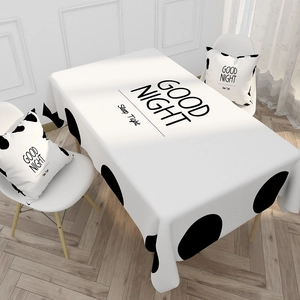 Detail of waterproof cotton linen tablecloth and pillows with black polka dots and text