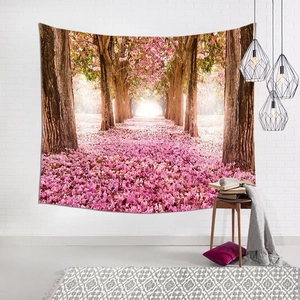 Detailed view of pink cherry blossom forest tapestry on a white brick wall in a cozy room
