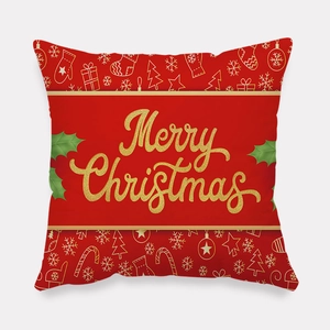 Detail of red Christmas pillowcase with golden Merry Christmas text and festive patterns