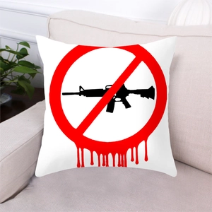 Detail of peach skin anti-gun pillow cover on a sofa featuring a black rifle silhouette