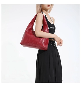 Detail of red woven hobo bag showing intricate texture and spacious shoulder strap design