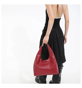 Detail view of red woven leather hobo bag showing intricate Intrecciato texture and design