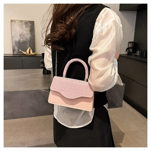 Pink sequin mini crossbody bag detail with silver chain strap and smooth leather finish