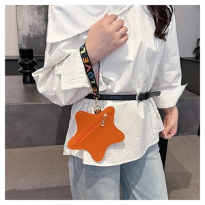 Close-up of star-shaped orange coin purse with LOVE embroidered strap and textured leather