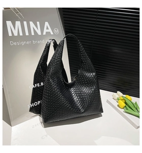Detail of classic black woven texture on large leather hobo tote bag for women