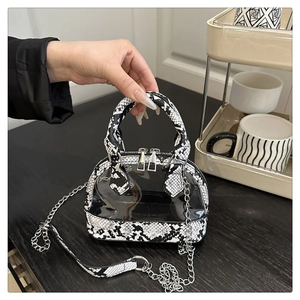 Detail of semi-transparent zebra print handbag with snake pattern leather and metal chain