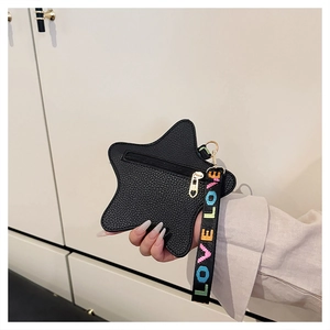 Detail of star-shaped faux leather coin purse with lychee texture and LOVE wrist strap