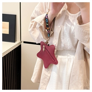 Star-shaped burgundy coin purse with lychee texture and GAEO woven wristlet strap
