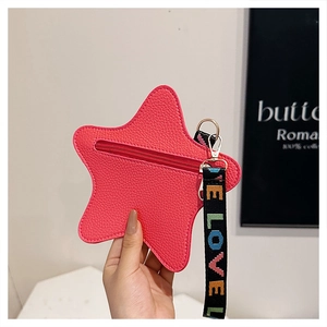 Detailed close-up of pink star-shaped coin purse with LOVE rainbow webbing handle