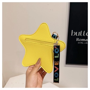 Detail of yellow star-shaped pouch with pebble grain texture and LOVE webbing strap