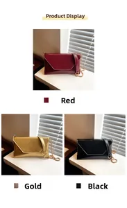 Vertical view of envelope chain bags in red, gold and black with glossy texture