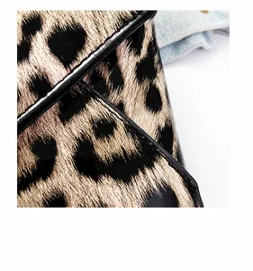 Close-up of leopard print crossbody bag showing precise edge stitching and fabric texture