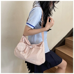 Detail of coral nylon crossbody bag with drawstring pleats and detachable round coin purse