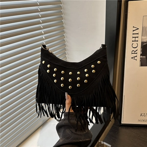 Bohemian black suede hobo bag with gold rivets and long fringes, modern folk style