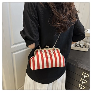 Close-up of retro red and white striped shell bag with metal frame and chain strap