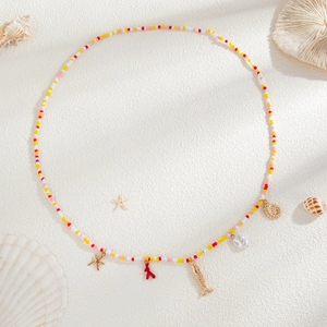 Detail of bohemian waist chain with colorful beads, starfish, and seashell pendants