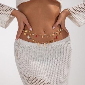 Double-layered gold body chain with ocean charms like starfish, shells, and pearls