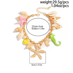 Detailed view of colorful starfish and seashell charms on a gold tone beach anklet