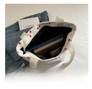 Interior view of the large capacity cherry print tote bag holding a tablet and books