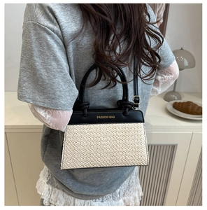 Detail of color-block crossbody bag featuring woven texture and Fashion Bag logo