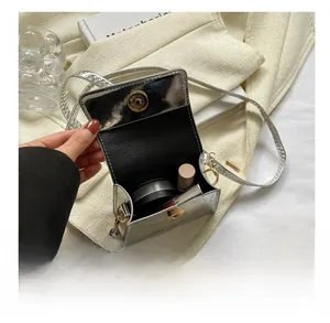 Interior view of silver crocodile pattern mini bag showing space for lipstick and makeup