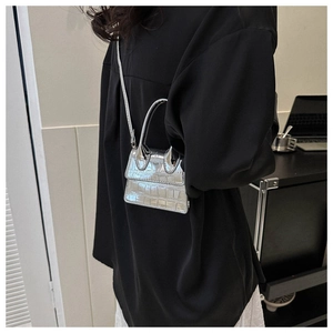 Detail of silver stone-patterned mini handbag with glossy finish and thin shoulder strap