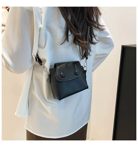 Modern black matte leather mini flap bag shown on model for size and style reference