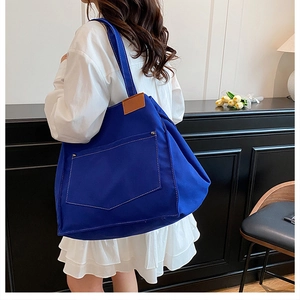 Large blue canvas tote bag for women, casual single shoulder bag with front pocket detail.