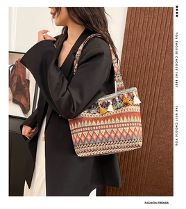 Macro detail of bohemian tote bag featuring colorful fringe tassels and ethnic patterns
